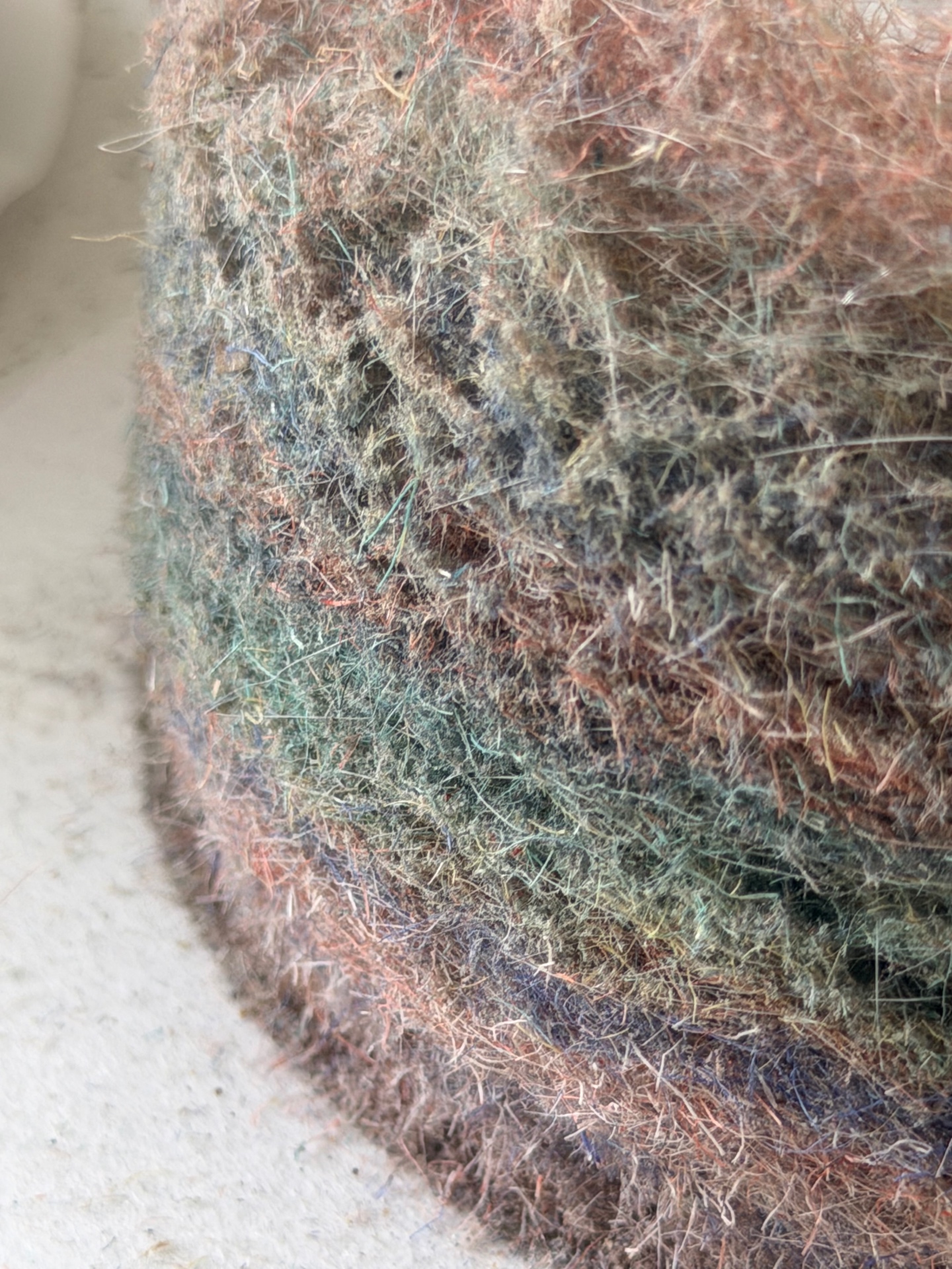 Dog hair, dust and coloured fibre cut away by trapped grit